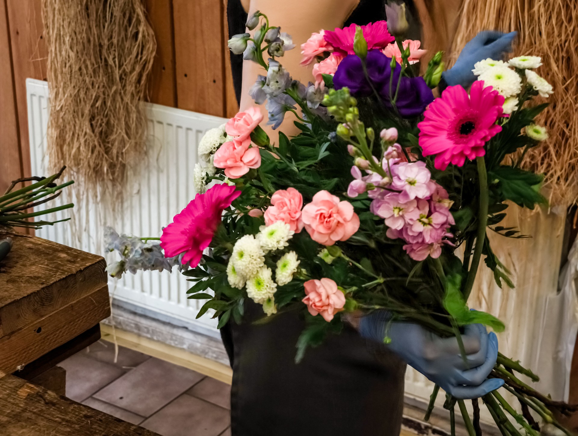 Florist arranging vibrant bouquet of colorful flowers